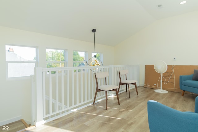 2302 Prospect St, Indianapolis, IN 46203 - living area featuring an upstairs landing, vaulted ceiling, wood finished floors, and baseboards