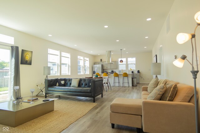 2302 Prospect St, Indianapolis, IN 46203 - living room featuring visible vents, baseboards, recessed lighting, and light wood-style floors