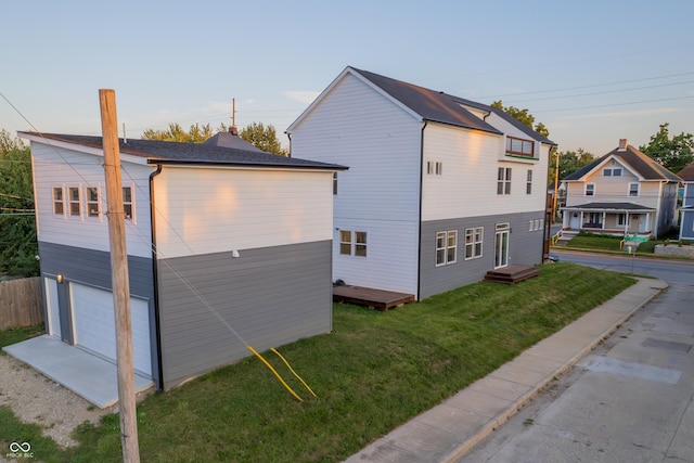 2302 Prospect St, Indianapolis, IN 46203 - view of home's exterior featuring a wooden deck, a lawn, a garage, and fence