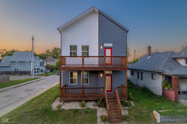 2302 Prospect St, Indianapolis, IN 46203 - back of property at dusk with covered porch and a yard