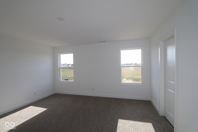 3832 Highcrest Rd, Indianapolis, IN 46239 - spare room with dark carpet and baseboards