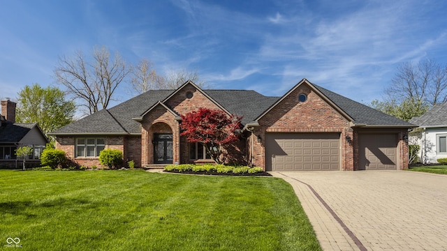view of front of house featuring decorative driveway, a front lawn, a shingled roof, an attached garage, and brick siding
