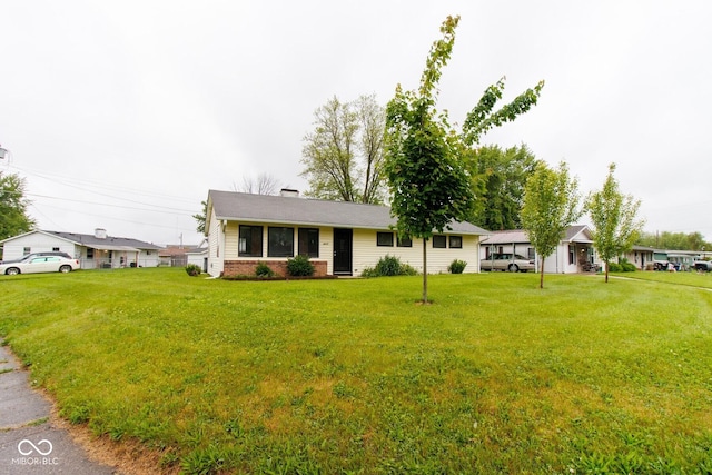 4917 Algonquin Trl, Kokomo, IN 46902 - ranch-style house with brick siding, a front yard, and a chimney