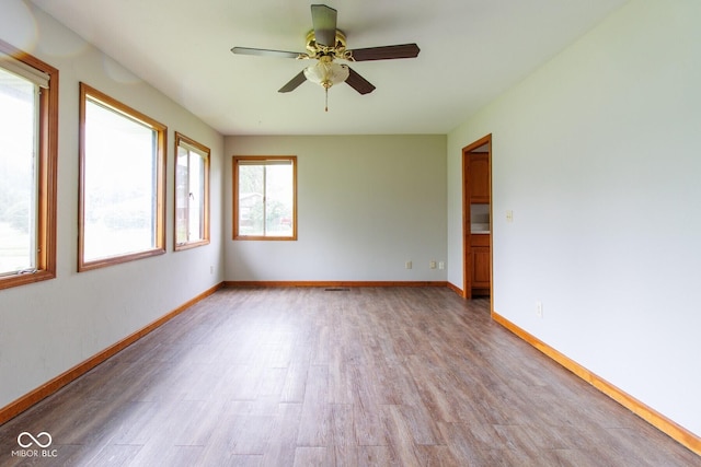 4917 Algonquin Trl, Kokomo, IN 46902 - empty room with light wood finished floors, ceiling fan, and baseboards