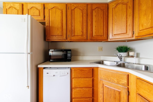 4917 Algonquin Trl, Kokomo, IN 46902 - kitchen featuring white appliances, a sink, light countertops, and brown cabinets