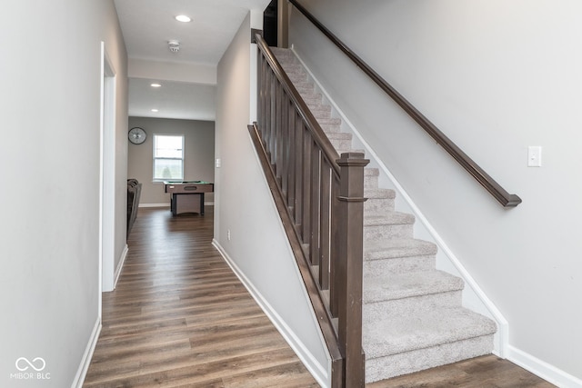 stairway with recessed lighting, wood finished floors, and baseboards