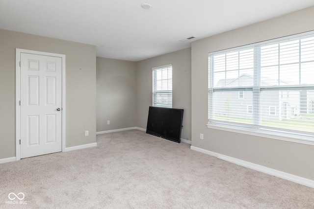 unfurnished room featuring visible vents, baseboards, and carpet floors
