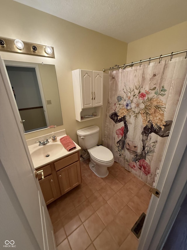 full bath with tile patterned floors, visible vents, toilet, vanity, and a textured ceiling
