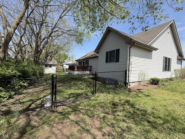 view of property exterior with a gate, fence, a shingled roof, a yard, and crawl space