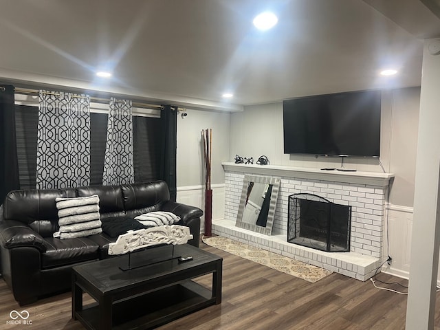 7206 Halden Pl, Indianapolis, IN 46214 - living room featuring a decorative wall, wood finished floors, wainscoting, a fireplace, and recessed lighting