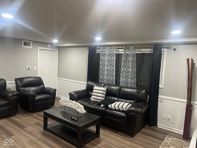 7206 Halden Pl, Indianapolis, IN 46214 - living area featuring wood finished floors, a wainscoted wall, a decorative wall, and recessed lighting