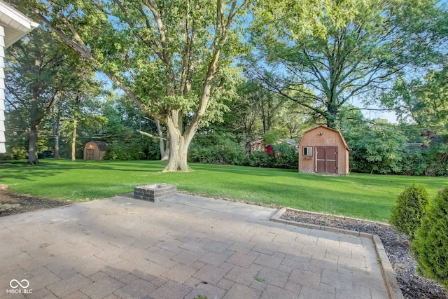 7206 Halden Pl, Indianapolis, IN 46214 - view of patio featuring a storage shed, an outbuilding, and view of wooded area