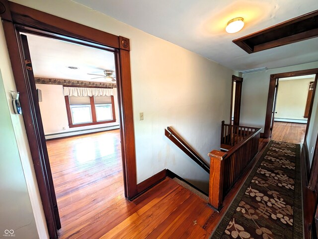4335 River Rd, Columbus, IN 47203 - hallway featuring an upstairs landing, a baseboard radiator, hardwood / wood-style flooring, a baseboard heating unit, and baseboards