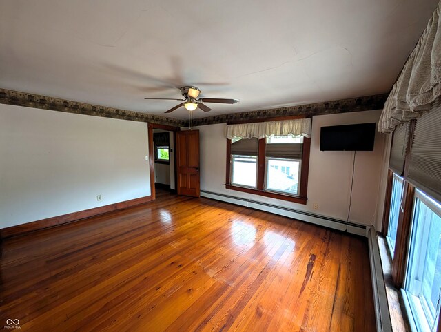 4335 River Rd, Columbus, IN 47203 - empty room featuring baseboard heating, ceiling fan, wood-type flooring, and baseboards