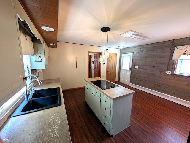 4335 River Rd, Columbus, IN 47203 - kitchen with black electric cooktop, a sink, baseboards, light countertops, and a center island