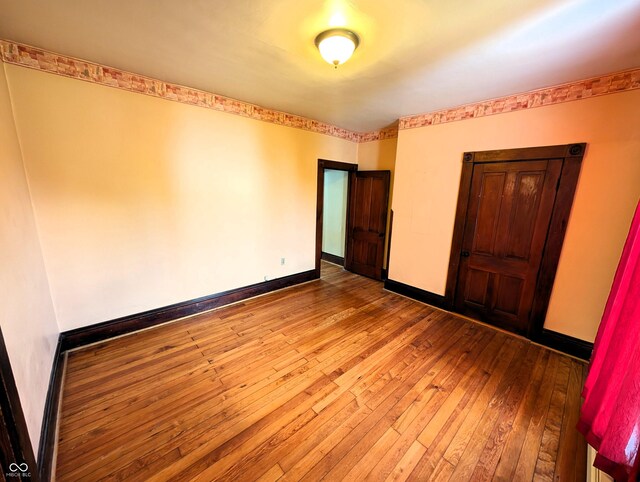 4335 River Rd, Columbus, IN 47203 - unfurnished bedroom with wood-type flooring and baseboards