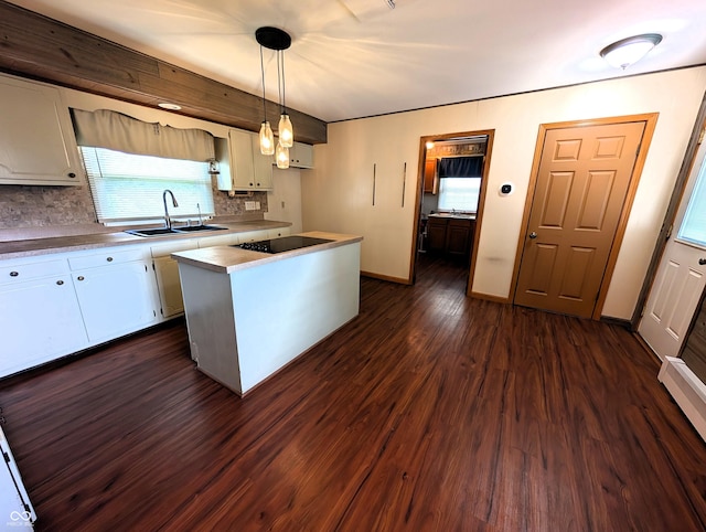4335 River Rd, Columbus, IN 47203 - kitchen with a sink, decorative backsplash, black electric cooktop, dark wood-style flooring, and white cabinetry