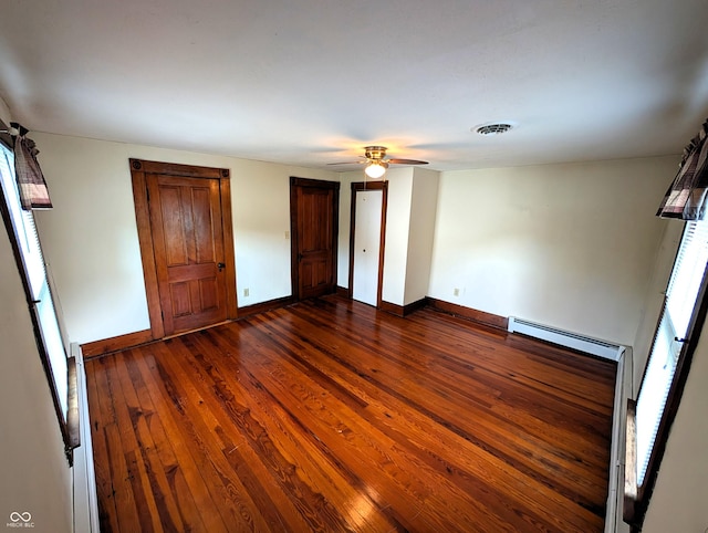 4335 River Rd, Columbus, IN 47203 - unfurnished bedroom featuring a baseboard radiator, baseboards, dark wood-style flooring, and ceiling fan