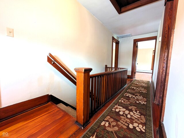 4335 River Rd, Columbus, IN 47203 - stairway with wood finished floors, baseboard heating, and baseboards