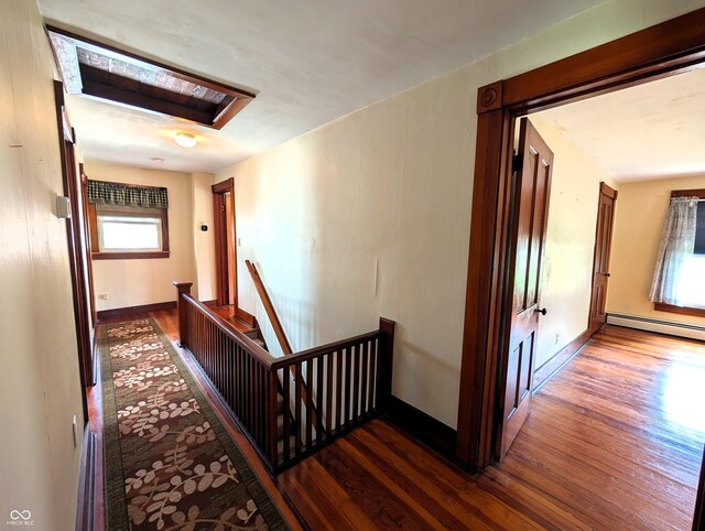 4335 River Rd, Columbus, IN 47203 - corridor featuring an upstairs landing, wood finished floors, a baseboard radiator, and baseboards