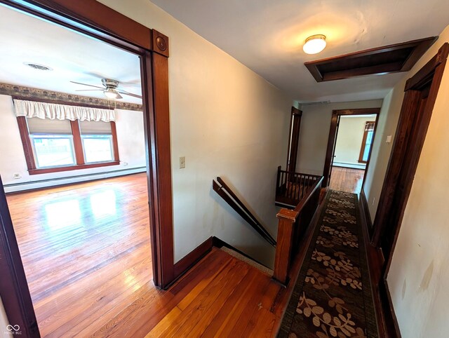 4335 River Rd, Columbus, IN 47203 - hall with an upstairs landing, wood finished floors, baseboard heating, baseboards, and a baseboard radiator