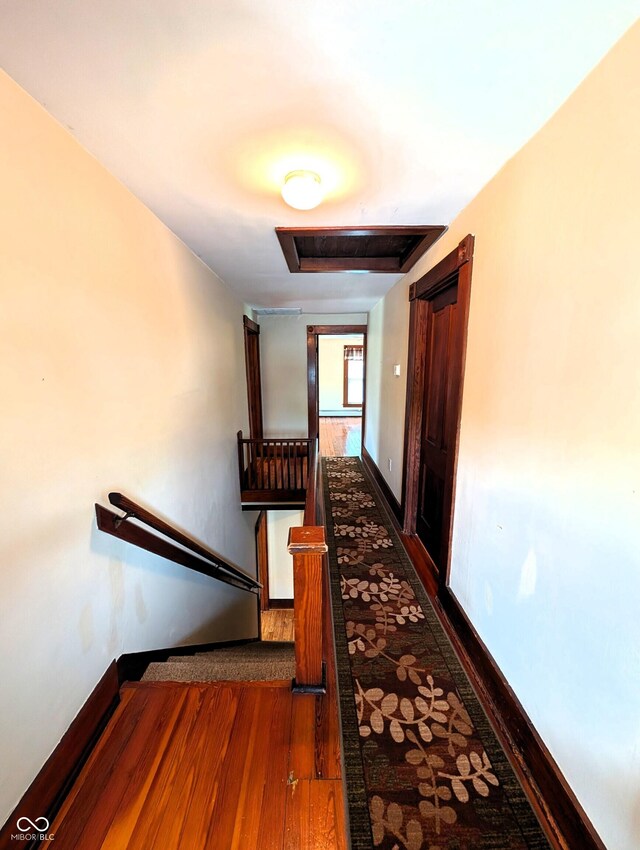 4335 River Rd, Columbus, IN 47203 - corridor featuring an upstairs landing, dark wood-style floors, and baseboards