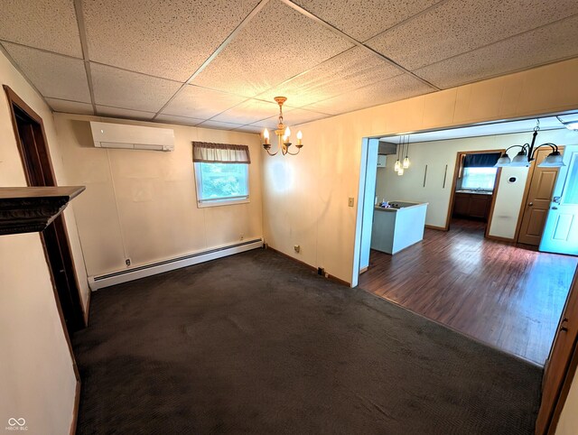 4335 River Rd, Columbus, IN 47203 - unfurnished dining area featuring a chandelier, baseboard heating, a wall unit AC, and a paneled ceiling