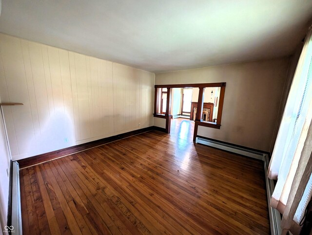 4335 River Rd, Columbus, IN 47203 - spare room with dark wood-style flooring, a baseboard heating unit, baseboard heating, and baseboards