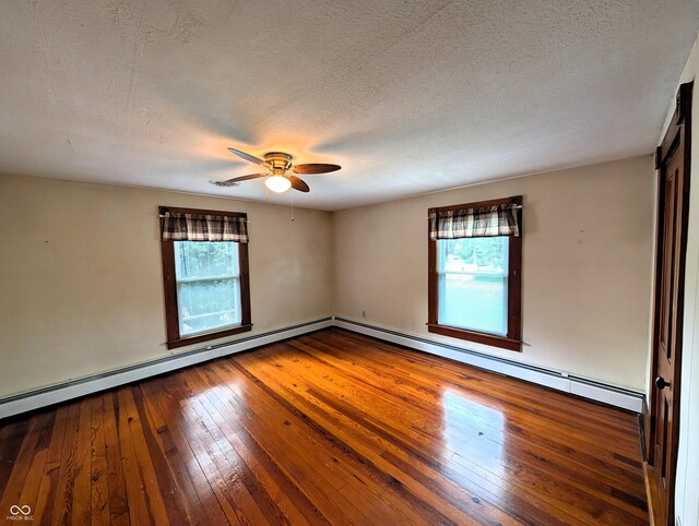 4335 River Rd, Columbus, IN 47203 - unfurnished room with healthy amount of natural light, a ceiling fan, wood-type flooring, and a textured ceiling