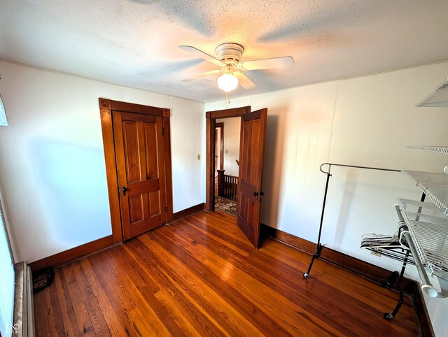 4335 River Rd, Columbus, IN 47203 - bedroom featuring dark wood-type flooring, baseboards, a textured ceiling, and ceiling fan