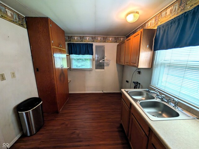 4335 River Rd, Columbus, IN 47203 - kitchen featuring a sink, dark wood-style flooring, brown cabinets, baseboards, and light countertops