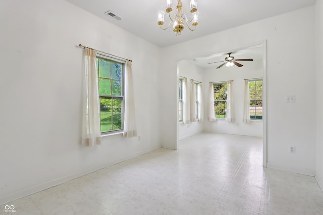unfurnished room featuring visible vents, baseboards, plenty of natural light, and ceiling fan with notable chandelier