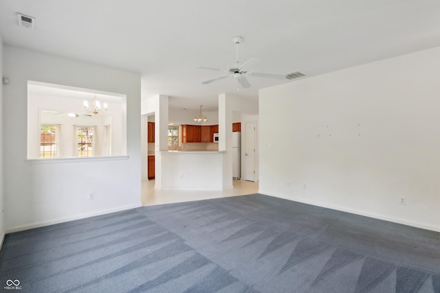 unfurnished living room with baseboards, visible vents, and light carpet