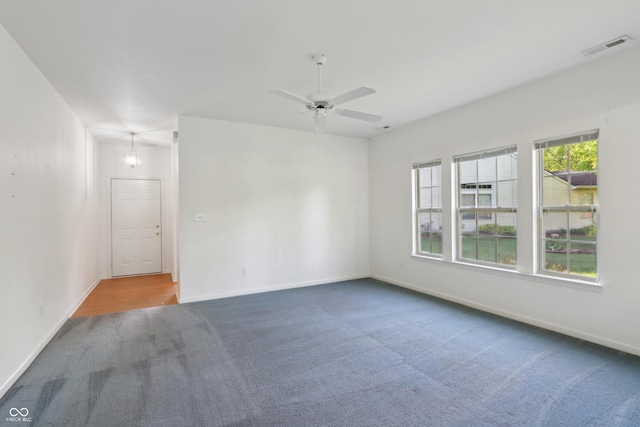 unfurnished room featuring carpet floors, baseboards, ceiling fan, and visible vents