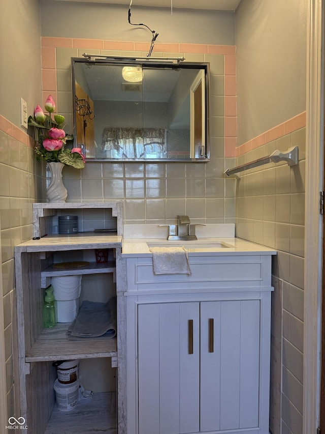 bathroom featuring decorative backsplash, vanity, and tile walls