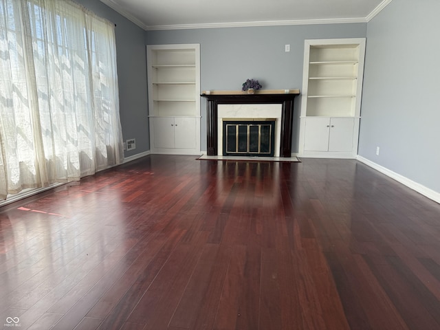 unfurnished living room with a fireplace with flush hearth, wood finished floors, and built in shelves