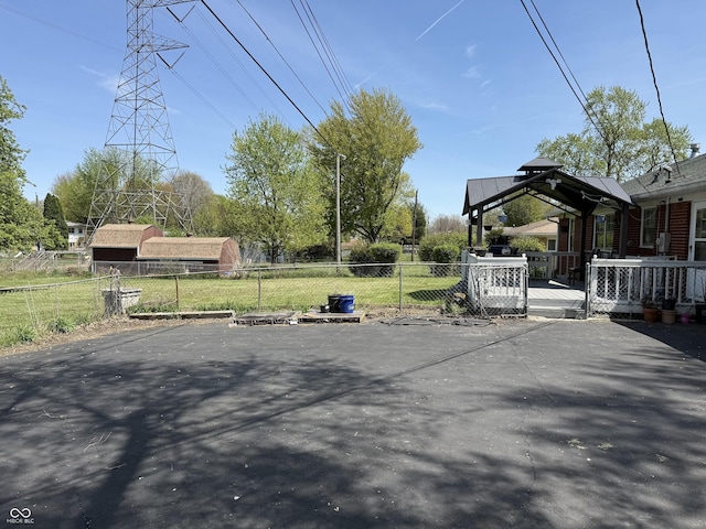 view of patio featuring fence and a wooden deck