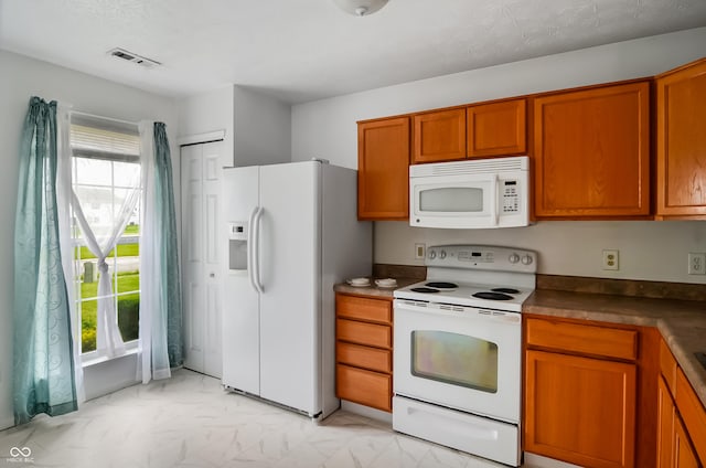 2138 Rossington Ln, Indianapolis, IN 46229 - kitchen featuring white appliances, light marble finish flooring, plenty of natural light, and brown cabinets