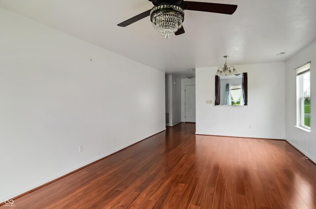 2138 Rossington Ln, Indianapolis, IN 46229 - spare room with ceiling fan, a chandelier, wood finished floors, and baseboards