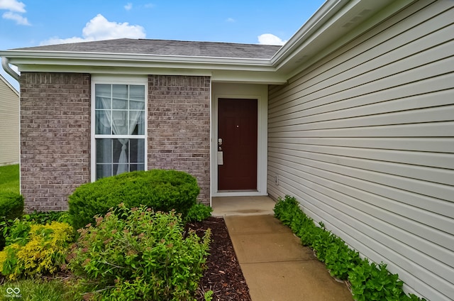 2138 Rossington Ln, Indianapolis, IN 46229 - doorway to property featuring a shingled roof and brick siding