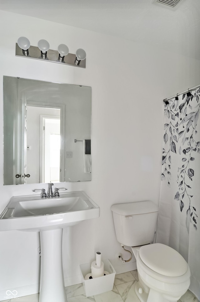 2138 Rossington Ln, Indianapolis, IN 46229 - full bath with marble finish flooring, toilet, curtained shower, and a sink