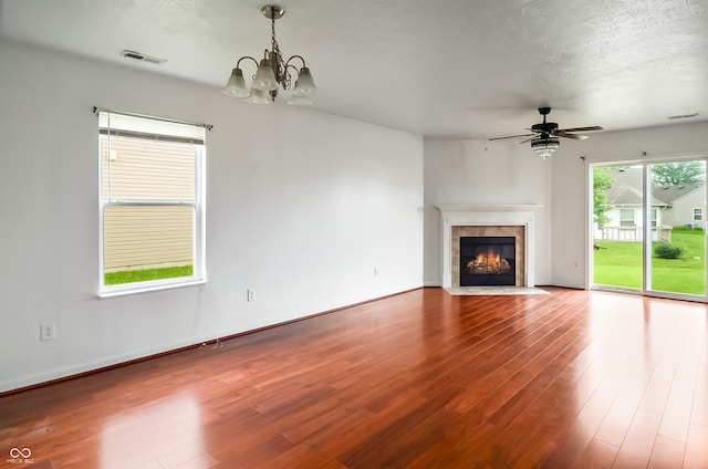 2138 Rossington Ln, Indianapolis, IN 46229 - unfurnished living room featuring wood finished floors, a chandelier, ceiling fan, and a tile fireplace