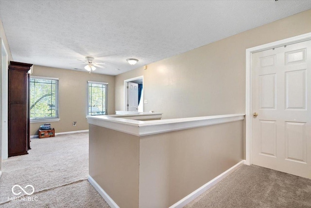 interior space with baseboards, carpet flooring, and a textured ceiling