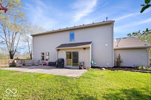 rear view of property featuring a lawn, fence, and a patio area