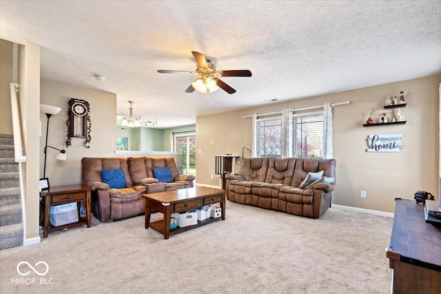 carpeted living area featuring stairs, a ceiling fan, a textured ceiling, and plenty of natural light