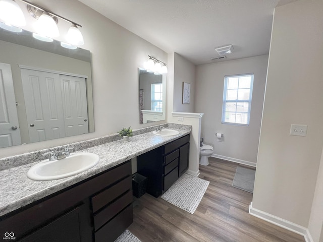 4245 W Fork Dr, Westfield, IN 46062 - bathroom featuring toilet, double vanity, wood finished floors, and baseboards
