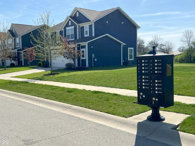 4245 W Fork Dr, Westfield, IN 46062 - view of side of home with mail area, a yard, concrete driveway, and an attached garage