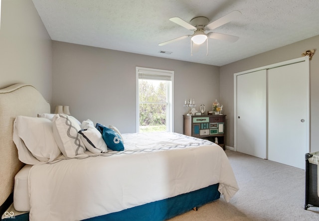6054 Easy Ln, Indianapolis, IN 46259 - bedroom with light carpet, a closet, a ceiling fan, and a textured ceiling