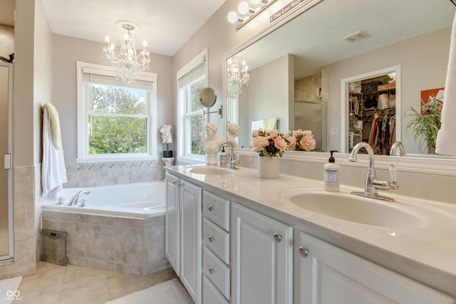 6054 Easy Ln, Indianapolis, IN 46259 - bathroom featuring a chandelier, a stall shower, double vanity, tile patterned floors, and a garden tub