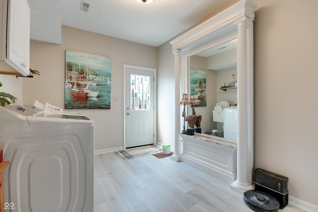 6054 Easy Ln, Indianapolis, IN 46259 - laundry area with washer and clothes dryer, decorative columns, cabinet space, light wood-style floors, and baseboards